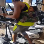 Woman Gyms With Baby Strapped To Her Back